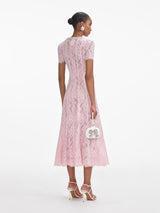 Back view of a woman wearing the Pink Lace Embellished Midi Dress