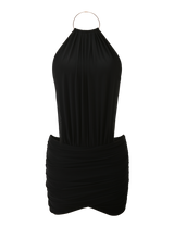 The EVANNA MINI DRESS by TIGERMIST is a black halter-neck mini dress with a gathered, ruched skirt, open back, and metallic ring closure.